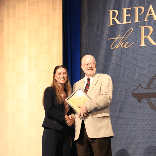 chrysostom oratory contest winner mariana eidson receiving award from david goodwin